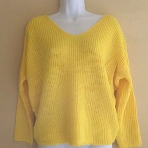 Yellow knitted sweater with know on back